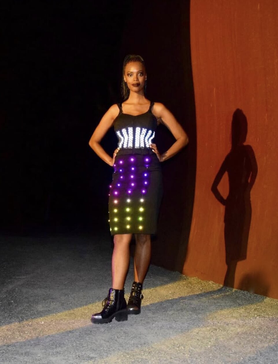 Performer singing on stage wearing Lumen Couture LED bodysuit at night