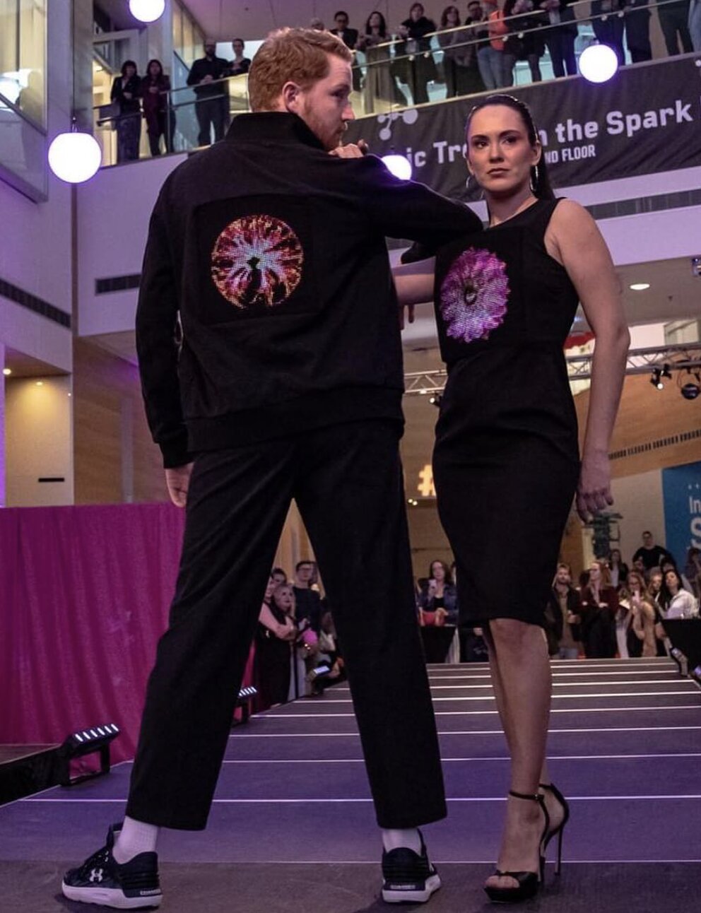 Couple wearing programmable LED fashion at MakeFashion show